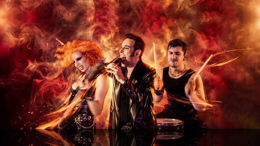 A vibrant rock band performing on stage with dramatic lighting; a singer holding a microphone, a guitarist with wild red hair, and a drummer energetically playing.